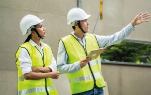 Construction workers implementing principles from the NEBOSH Health and Safety Courses 