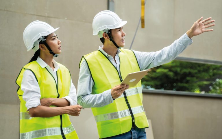 Construction workers using knowledge from the NEBOSH Health and Safety Course.