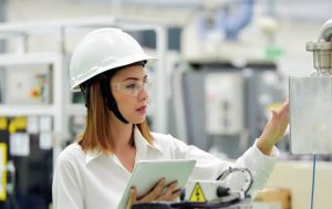 Worker in PPE performing safety checks after their NEBOSH Health and Safety Course