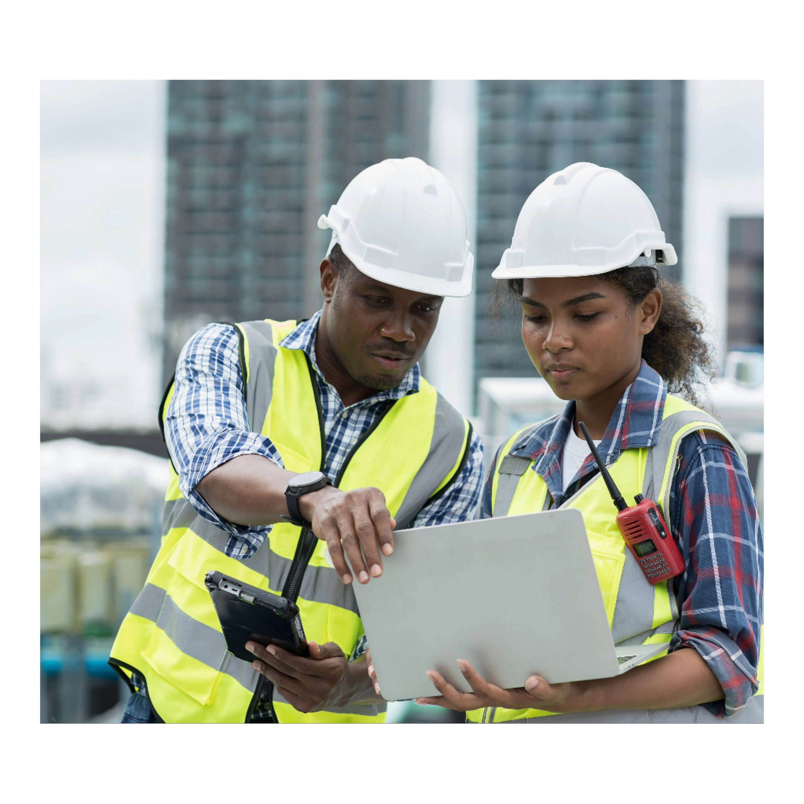 Two constructions workers with Red CSCS card examining a design blueprint.