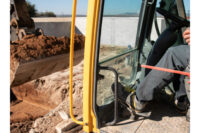 Groundworker carrying out excavation on construction site.