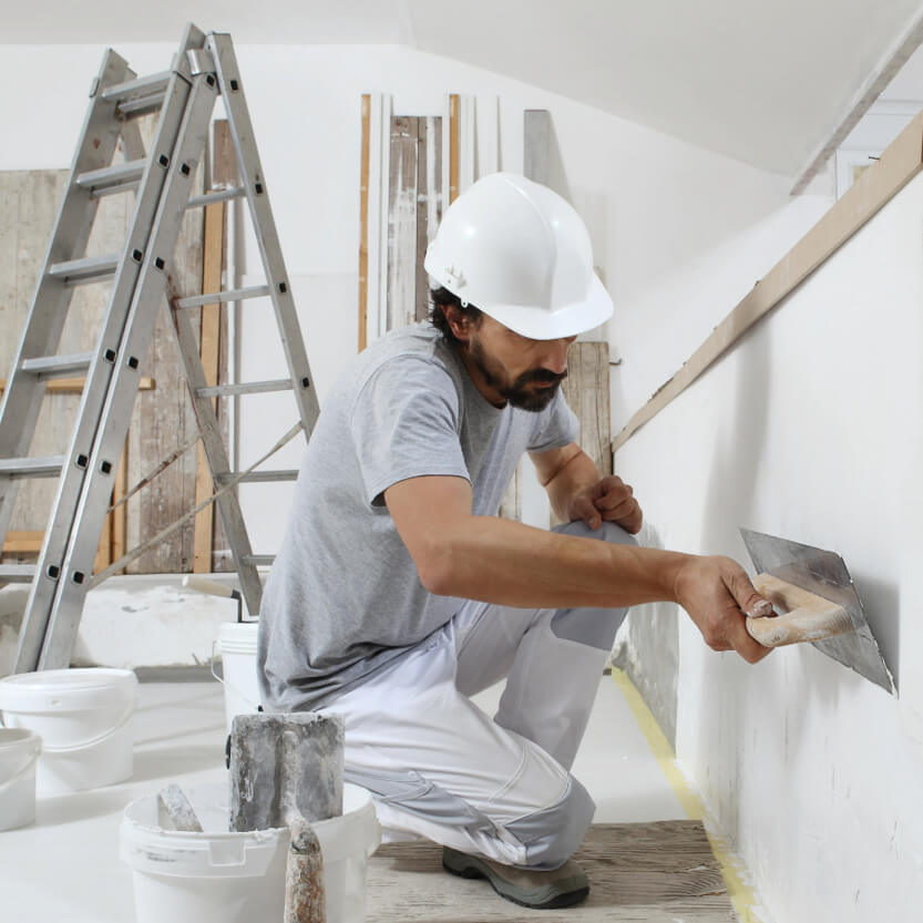 Trade worker plastering for their Level 2 NVQ