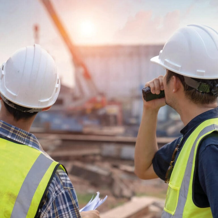 Two construction workers Supervising on site completing their Level 4 NVQ