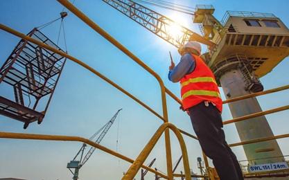 Construction worker giving signals for the practical of the Slinger Signaller Level 2 NVQ