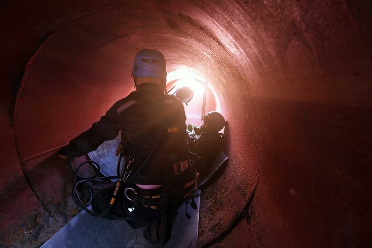 workers in a confined space tunnel undergoing training