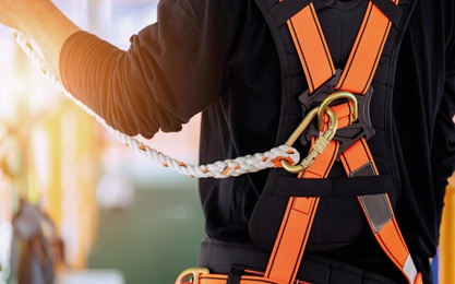Worker on site using knowledge from the Safety Harness Training