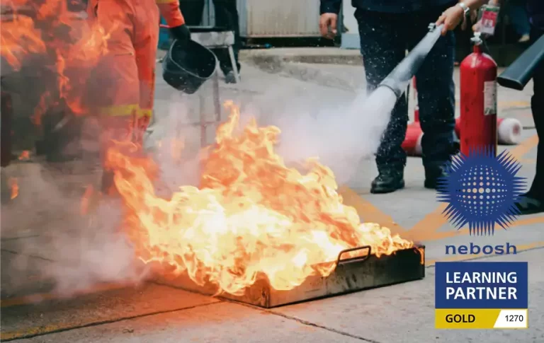 NEBOSH Fire Safety Trained person putting out a fire