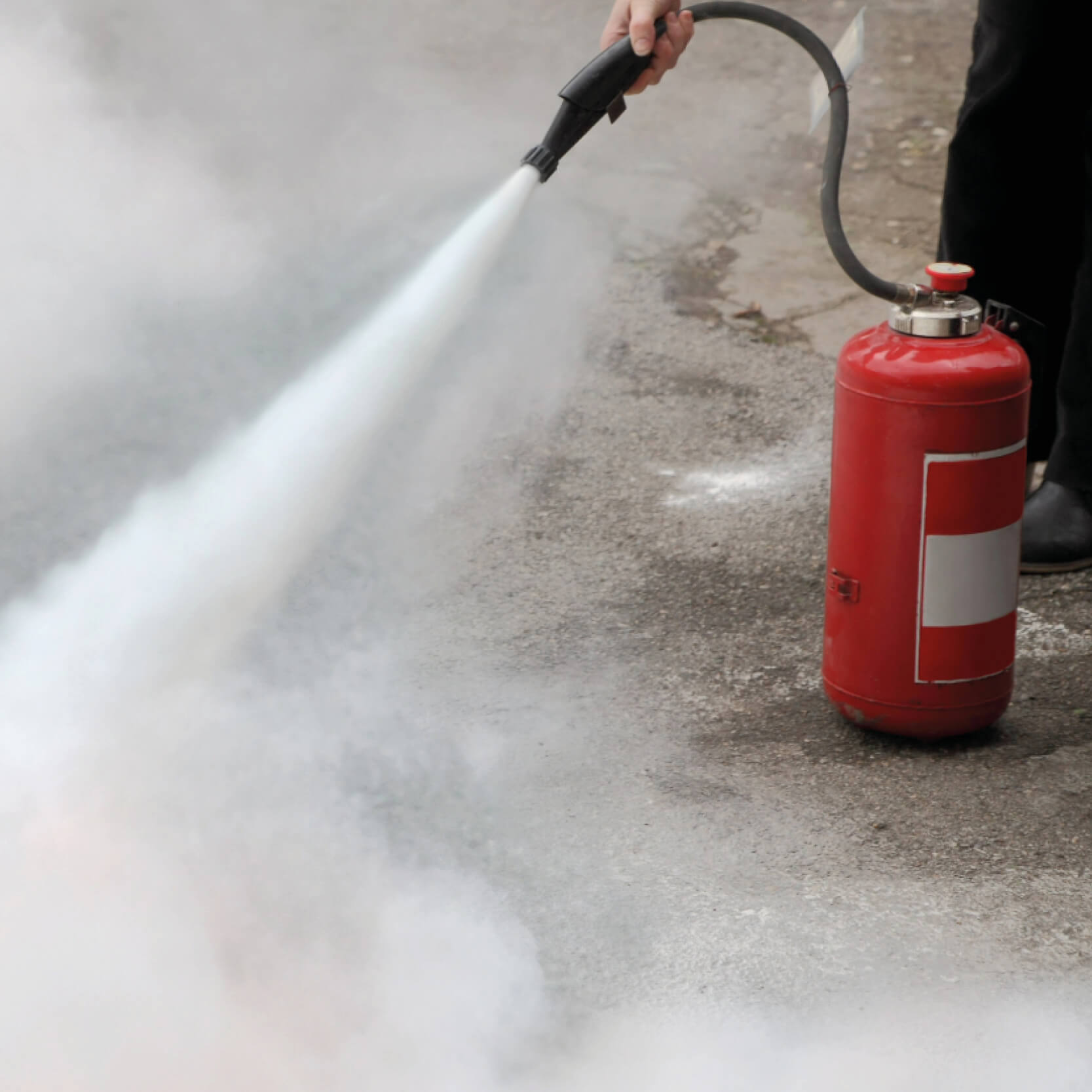 Fire extinguisher being used after completing the NEBOSH Fire Safety course
