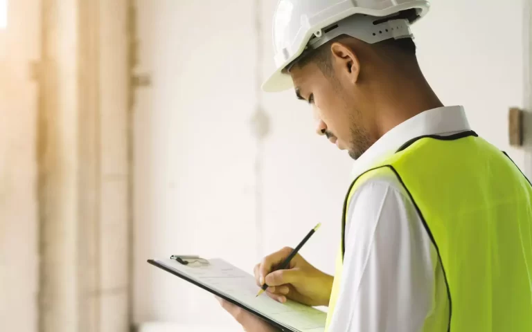 NEBOSH Construction trained worker carrying our risk assessment