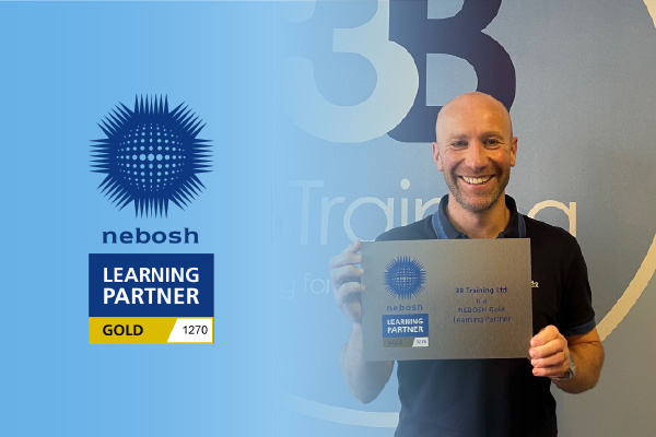 Managing Director at 3B Training holding up NEBOSH plaque to announce we have received Gold Learning Partner status.