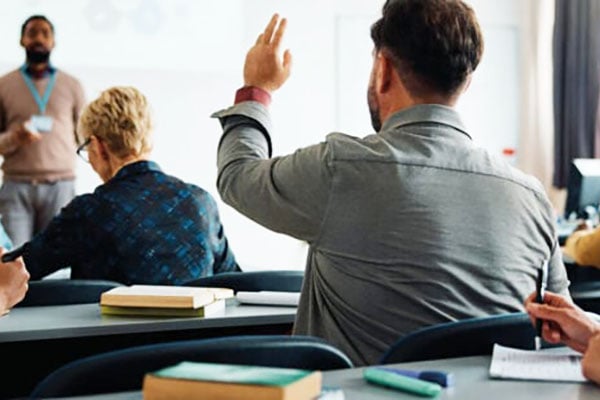 Trainer starting a training course and answering questions