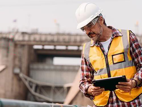 A senior construction worker completing health and safety checks.