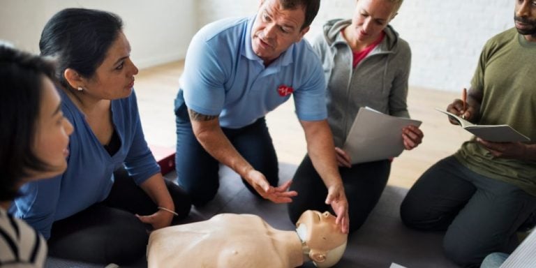 A tutor shows delegates how to perform CPR