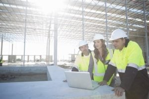 what is a level 4 nvq - 3 construction workers looking at laptop screen