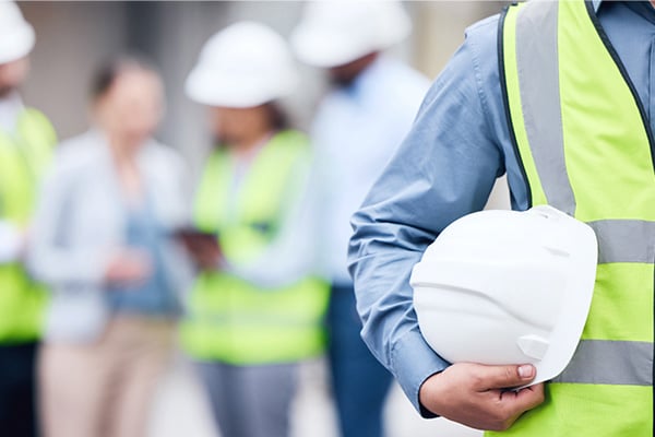 Constructin man holding hard hat