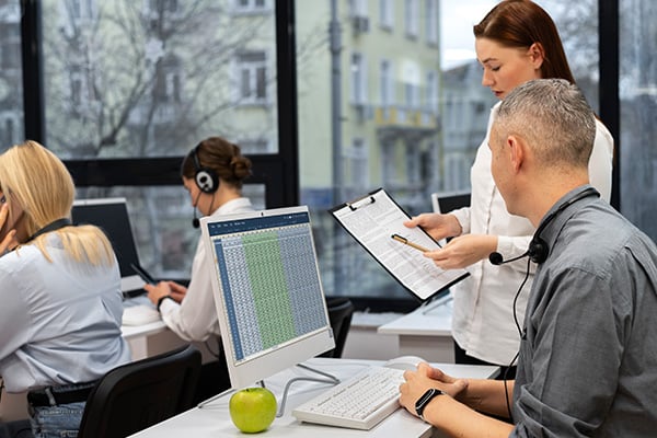 Co-workers discussing a risk assessment to identify and mitigate office hazards