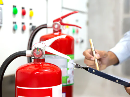 Responsible person completing a fire safety checklist in their workplace.