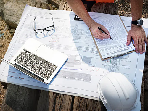 Safety professional carrying out risk assessment in accordance of the new NEBOSH Construction Certificate syllabus.