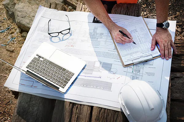 Risk assessments being conducted by a safety professional to align with the new NEBOSH Construction Certificate syllabus.