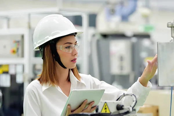 Manager performing safety checks after NEBOSH Health and Safety training.